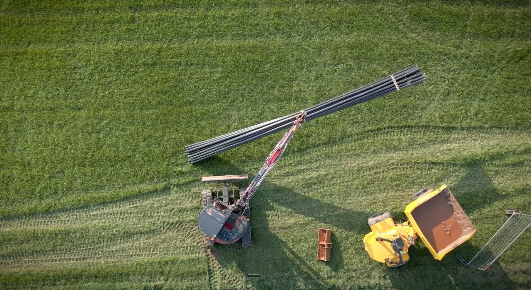 An excavator moving the HDPE cable ducts into position on site at Iron Acton before butt-fusion welding