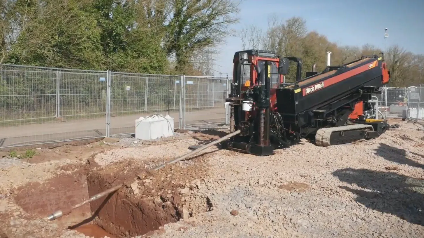 A Ditch Witch directional drilling rig boring from the launch pit on the Iron Acton grid-connection site
