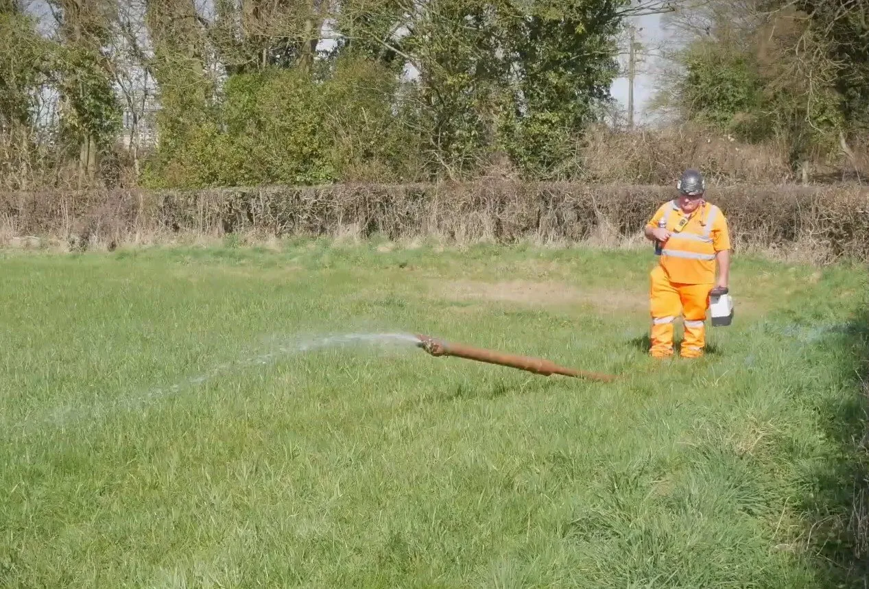 The pilot drill head breaking out of the ground at Iron Acton with drilling fluid running off